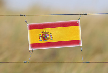 Image showing Border fence - Old plastic sign with a flag