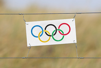 Image showing Border fence - Old plastic sign with a flag