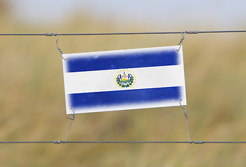 Image showing Border fence - Old plastic sign with a flag