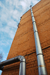 Image showing two ventilation pipes on a brick wall