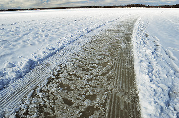 Image showing road and tracks on frozen snowcovered lake