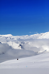 Image showing Winter snowy mountains and ski slope at nice day