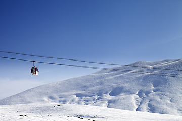 Image showing Gondola lift and ski slope at nice sun day