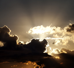 Image showing Sunset sky with dark clouds and sun rays