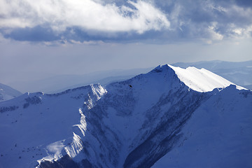 Image showing Winter mountains and helicopter in evening