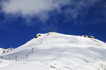 Image showing Ropeway and ski slope in sun day