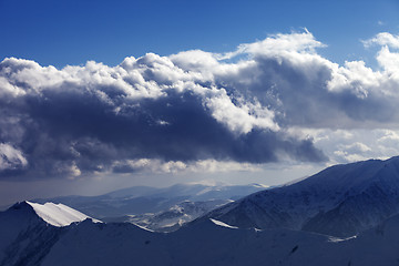 Image showing Winter mountains in evening and sunlight clouds