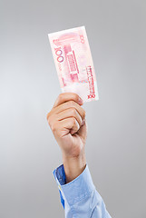 Image showing Businessman hand hold with hundred RMB