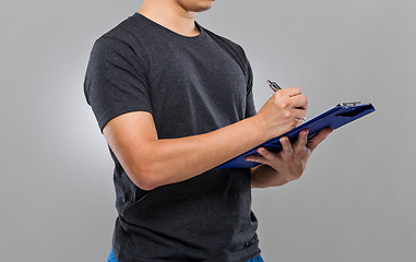 Image showing Man write on clipboard