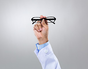 Image showing Optician doctor hold with eye glasses