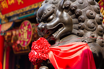 Image showing Lion statue in front of chinese temple 