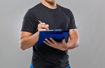 Image showing Man write on clipboard