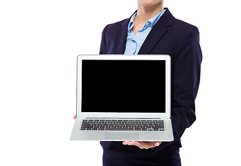 Image showing Businesswoman show with blank screen of laptop computer