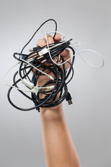 Image showing Hand hold with messy cable