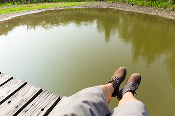 Image showing Man with hiking shoes on wooden floor