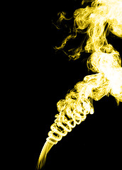 Image showing Yellow smoke on black