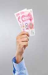 Image showing Businessman hold with chinese yuan