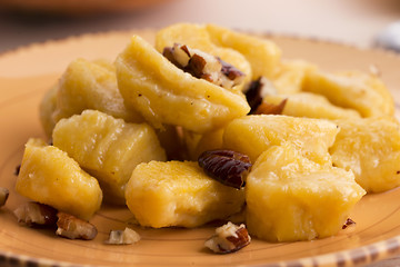 Image showing homemade pumpkin gnocchi with pecan nuts