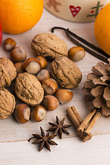 Image showing Different kinds of spices, nuts and dried oranges - christmas de