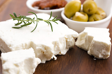 Image showing Feta cheese with olives, sun dried tomatoes and fresh herbs