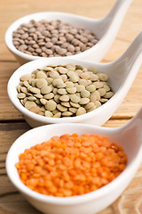 Image showing Three kinds of lentil in bowls - red lentil, green lentil and br