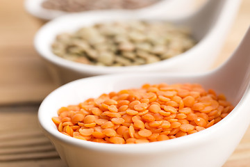 Image showing Three kinds of lentil in bowls - red lentil, green lentil and br