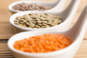 Image showing Three kinds of lentil in bowls - red lentil, green lentil and br