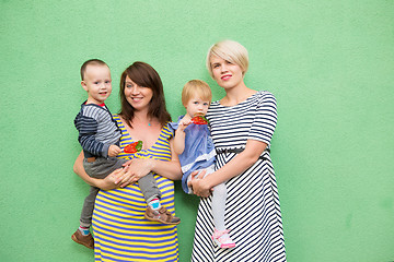 Image showing two beautiful girls with a children