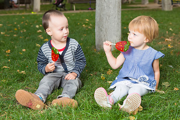 Image showing Adorable little kids with colorful lollipops