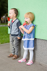 Image showing Adorable little kids with colorful lollipops