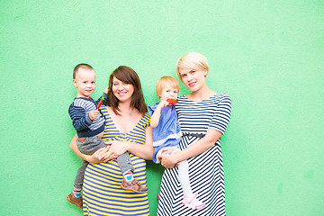 Image showing two beautiful girls with a children