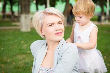 Image showing portrait of beautiful mother and kid girl outdoors in park