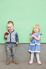 Image showing Adorable little kids with colorful lollipops