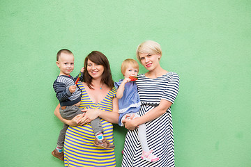 Image showing two beautiful girls with a children