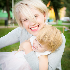 Image showing portrait of beautiful mother and kid girl outdoors in park