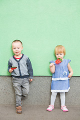 Image showing Adorable little kids with colorful lollipops