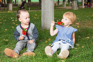 Image showing Adorable little kids with colorful lollipops