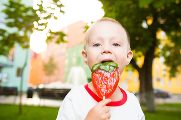 Image showing young boy with colorful lollipop