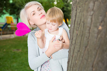Image showing portrait of beautiful mother and kid girl outdoors in park