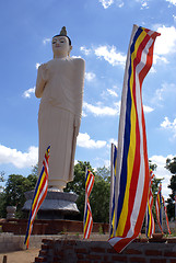 Image showing White Buddha and buddhist flags