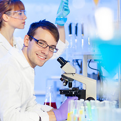 Image showing Portrait of a young male researcher microscoping