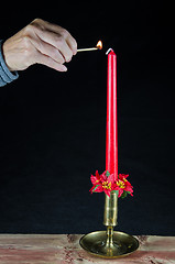 Image showing Lighting a christmas candle