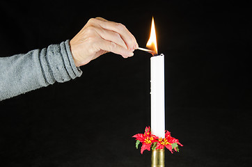 Image showing Lighting a christmas candle