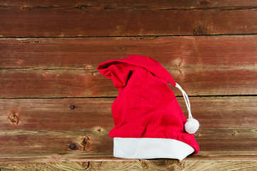 Image showing Santas cap at old weathered wooden background