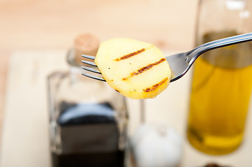 Image showing grilled potato on a fork
