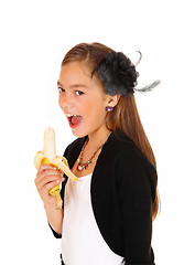 Image showing Girl eating banana.