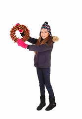 Image showing Girl holding a wreath up.