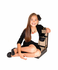Image showing Girl sitting in briefcase.