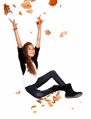 Image showing Girl with falling leaves.