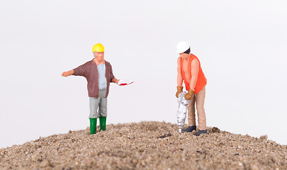 Image showing Miniature worker with a power drill